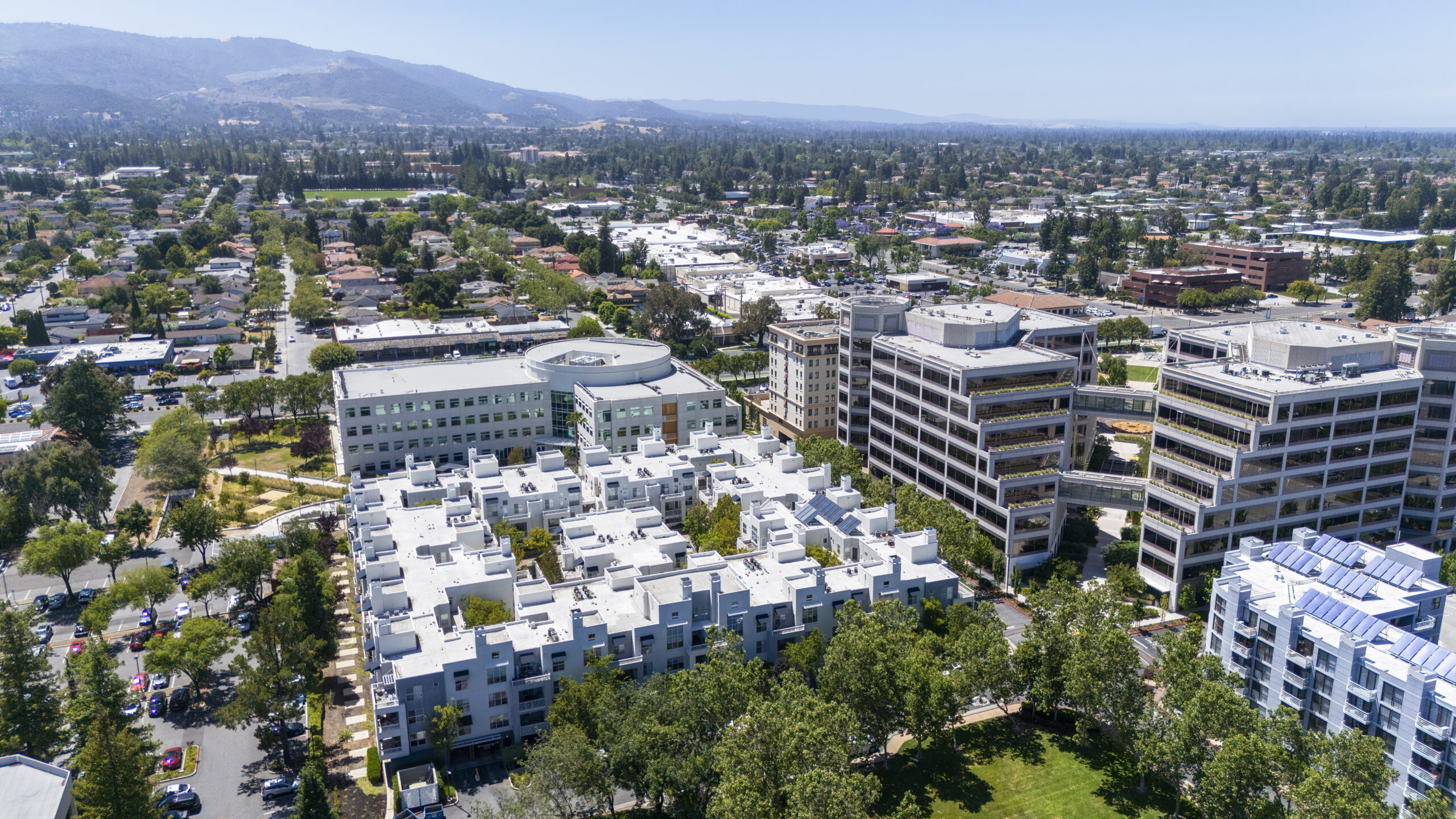 Green technology allows growing gardens on the rooftops and the buildings’ terraces. Cupertino modern financial and technological cityscape blends residential structures in Silicon Valley, California at Santa Cruz foothills